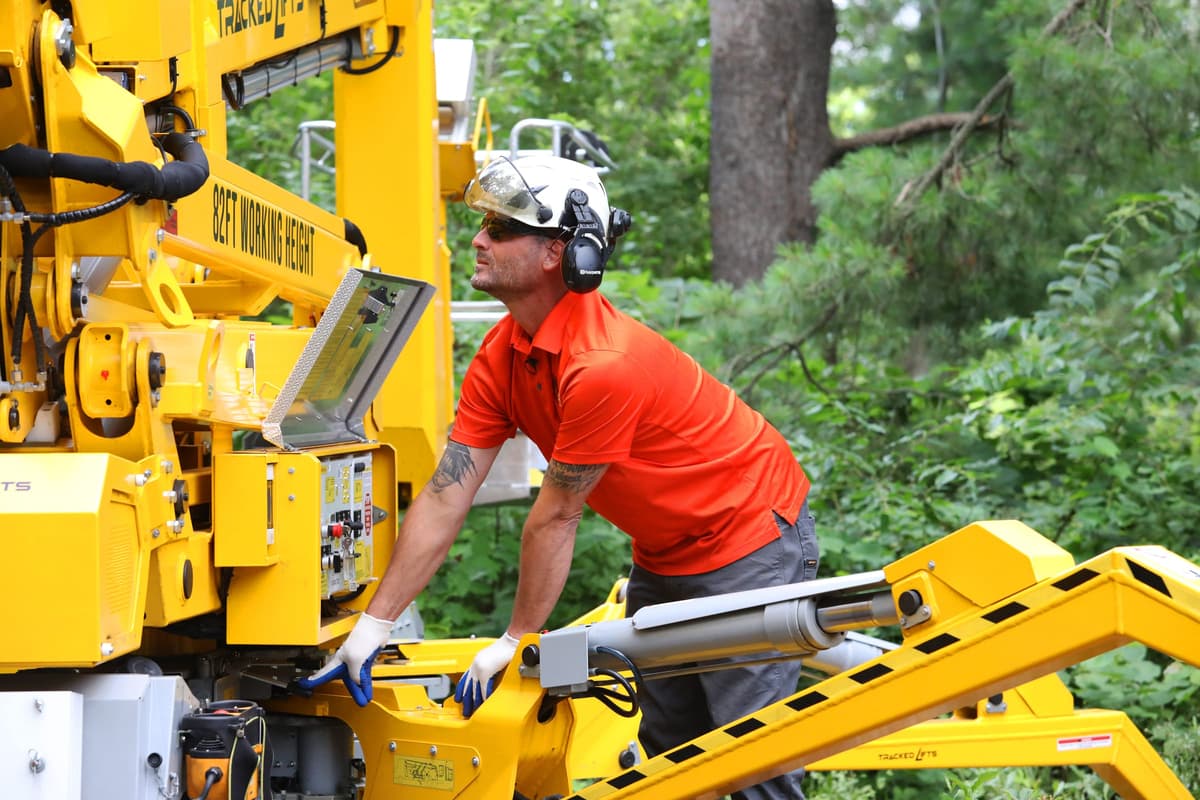 Tree Service Worker Performing Hazardous Tree Removal.